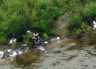 This photo, digitally altered to protect the identities of the victims, was taken from a helicopter above Utoya Island near Oslo, Norway. It shows what police believe is the alleged gunman walking among victims after opening fire on a youth retreat, killing at least 86, Friday, July 22, 2011. The mass shootings are among the worst in history. With the blast outside the prime minister’s office, they formed the deadliest day of terror in Western Europe since the 2004 Madrid train bombings killed 191. (AP Photo/NRK, Marius Arnesen via Scanpix)